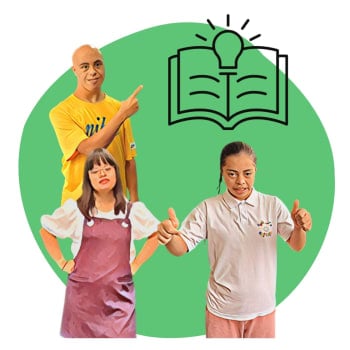 A group of people with Down syndrome looking happy beside a book with a lightbulb